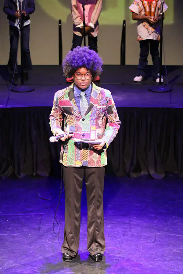 Performer with purple afro